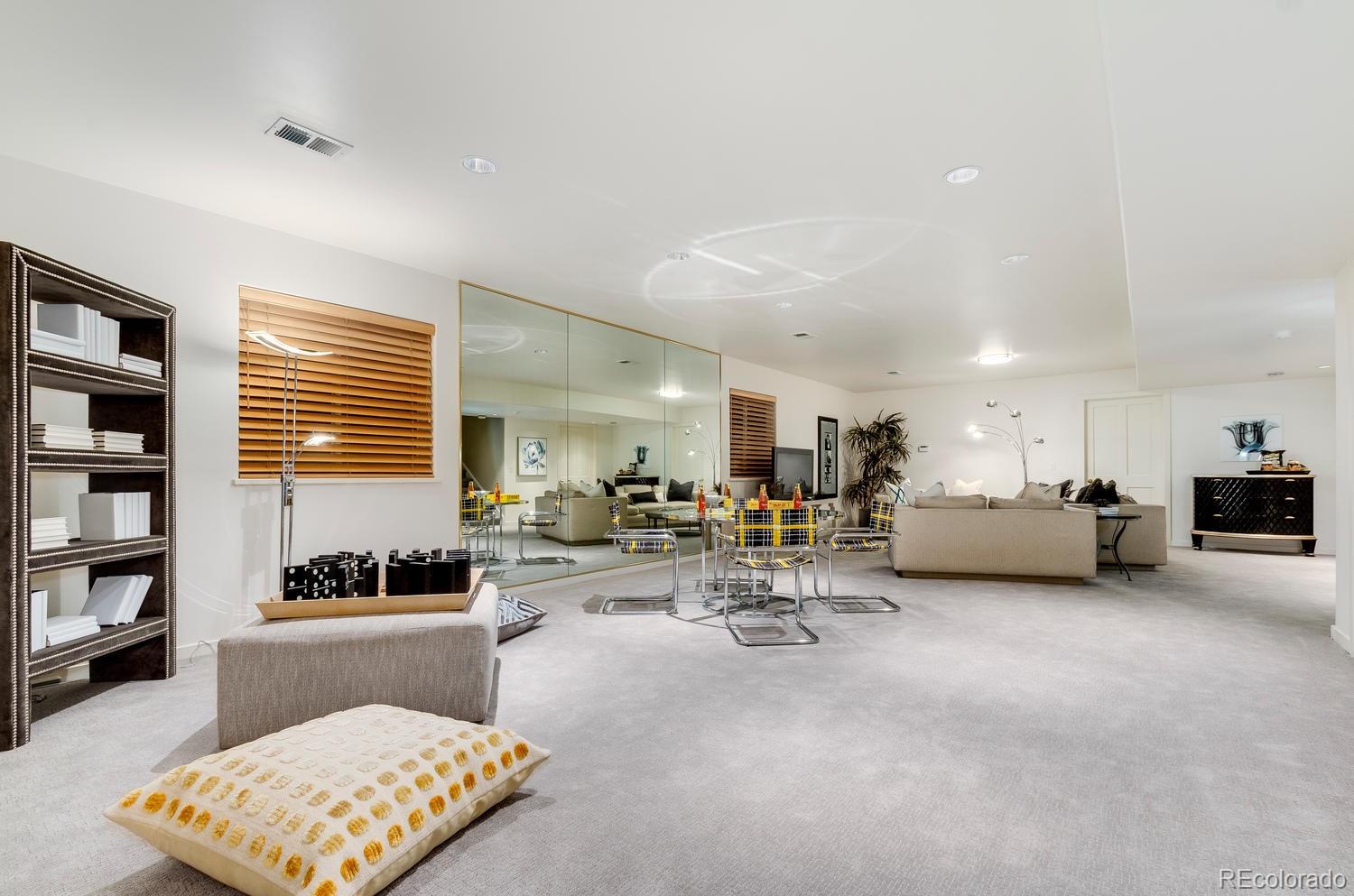 27 Hyde Park Circle Denver, CO 80209 - Photo 34 of 40 a living room with furniture and a book shelf
