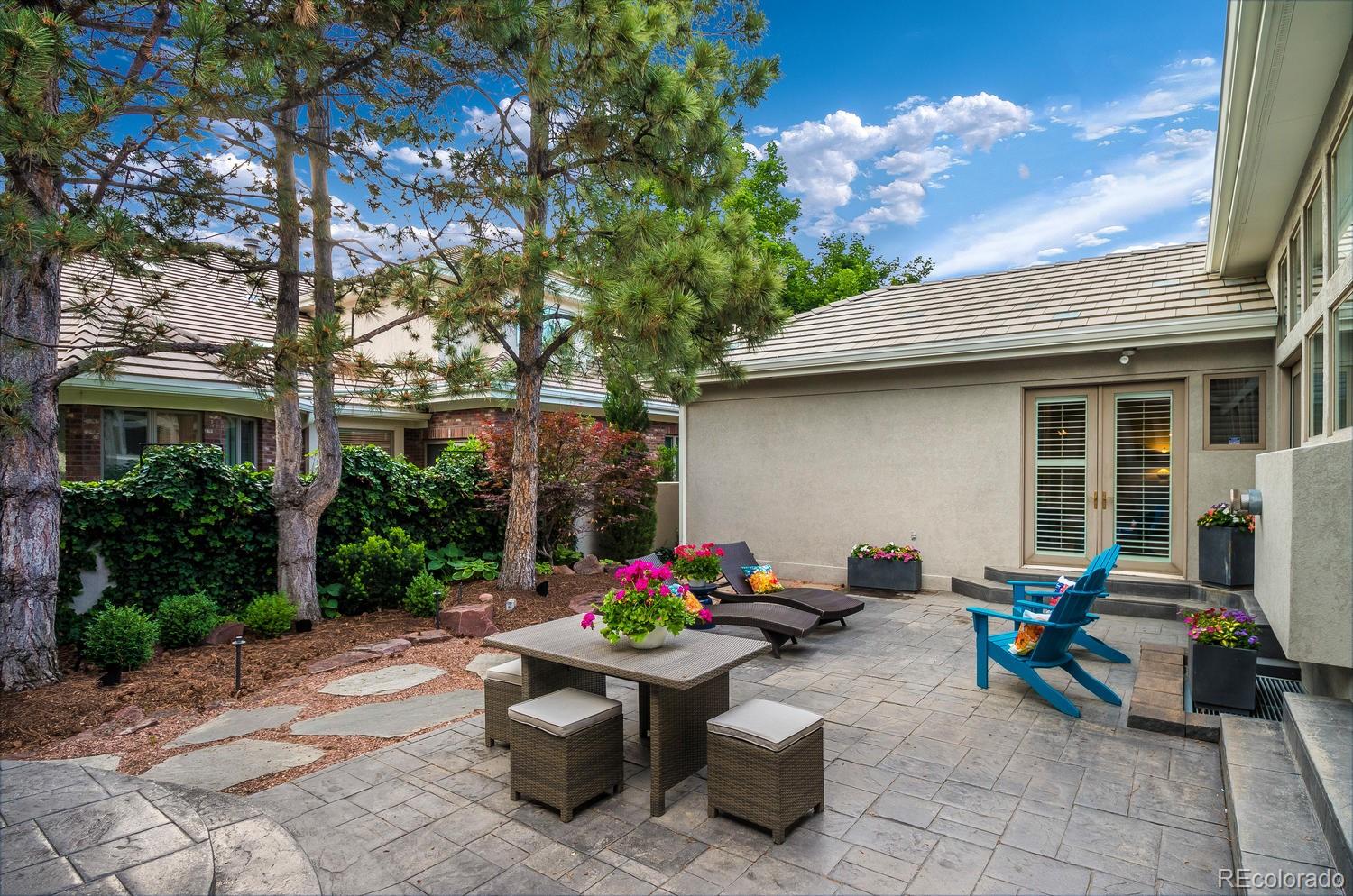 27 Hyde Park Circle Denver, CO 80209 - Photo 39 of 40 a view of a patio with table and chairs potted plants and a large tree