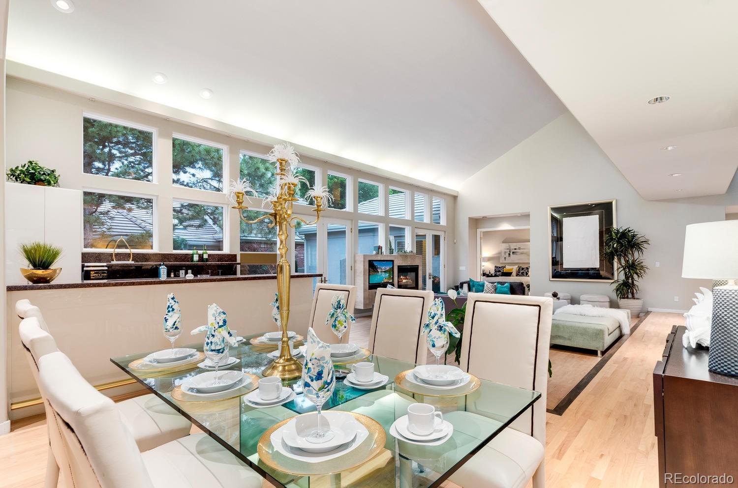 27 Hyde Park Circle Denver, CO 80209 - Photo 9 of 40 a dining room with furniture a large window and a kitchen view