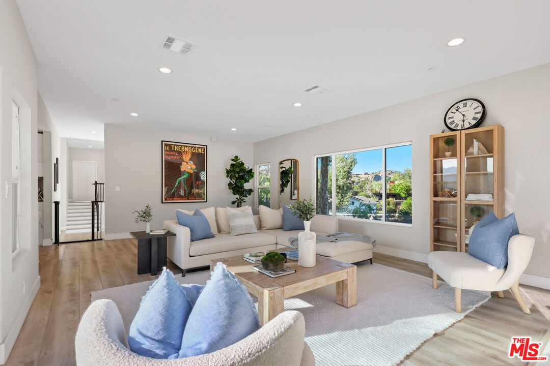 53 Saddlebow Road Bell Canyon, CA 91307 - Photo 19 of 66 a living room with furniture and a large window