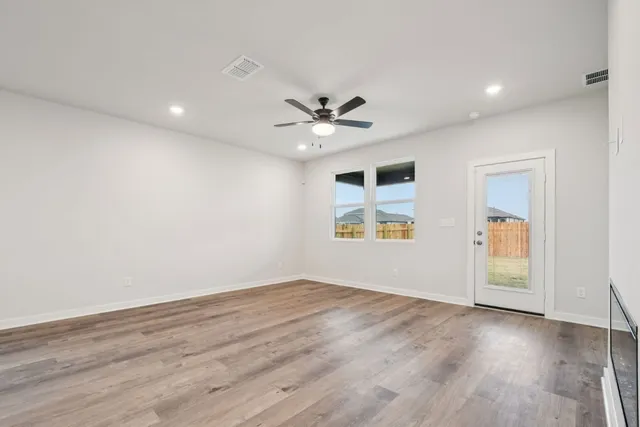 wooden floor in an empty room with a window