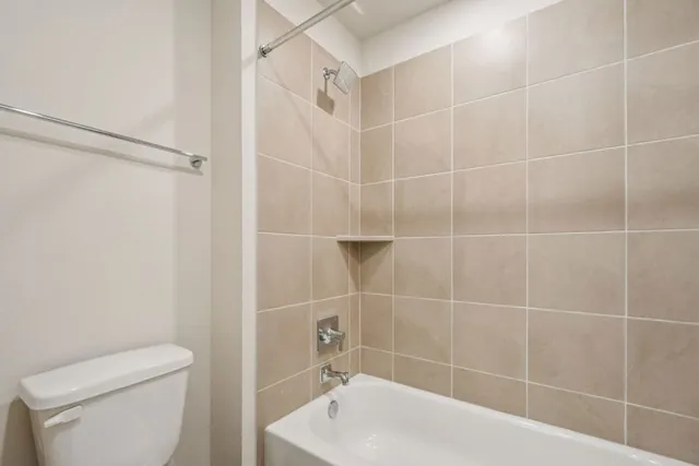 a bathroom with a toilet and a bathtub