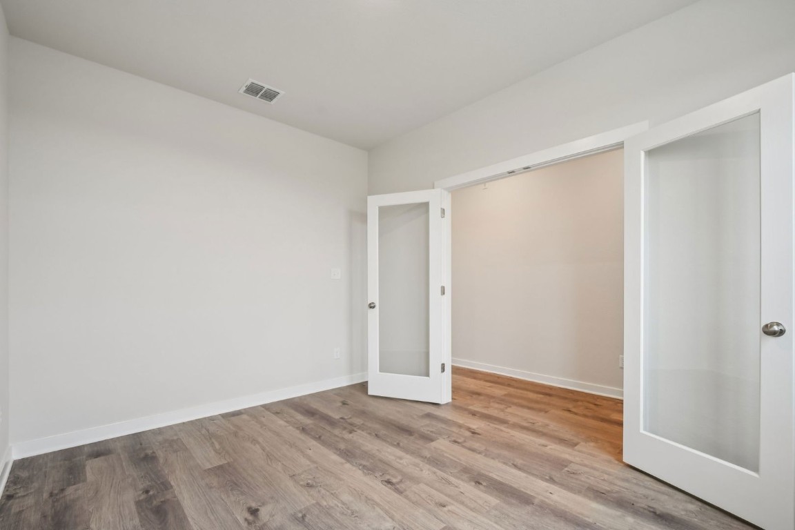 13417 Derby Ride Drive Buda, TX 78610 - Photo 27 of 38 a view of an empty room with wooden floor
