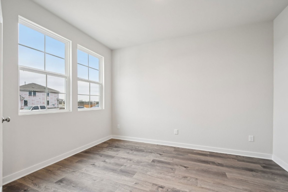 13417 Derby Ride Drive Buda, TX 78610 - Photo 28 of 38 wooden floor in an empty room with a window