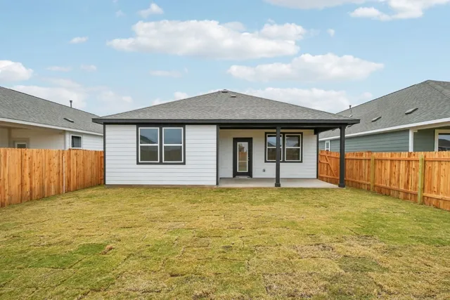 a view of a house with a swimming pool and a yard