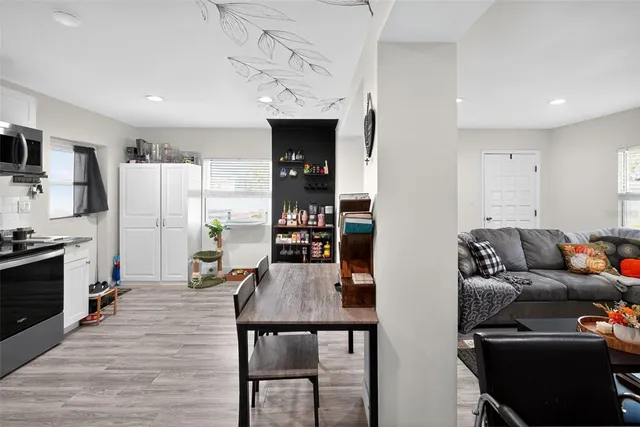 a living room with furniture and a kitchen view