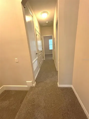 a view of a hallway with paintings on the wall