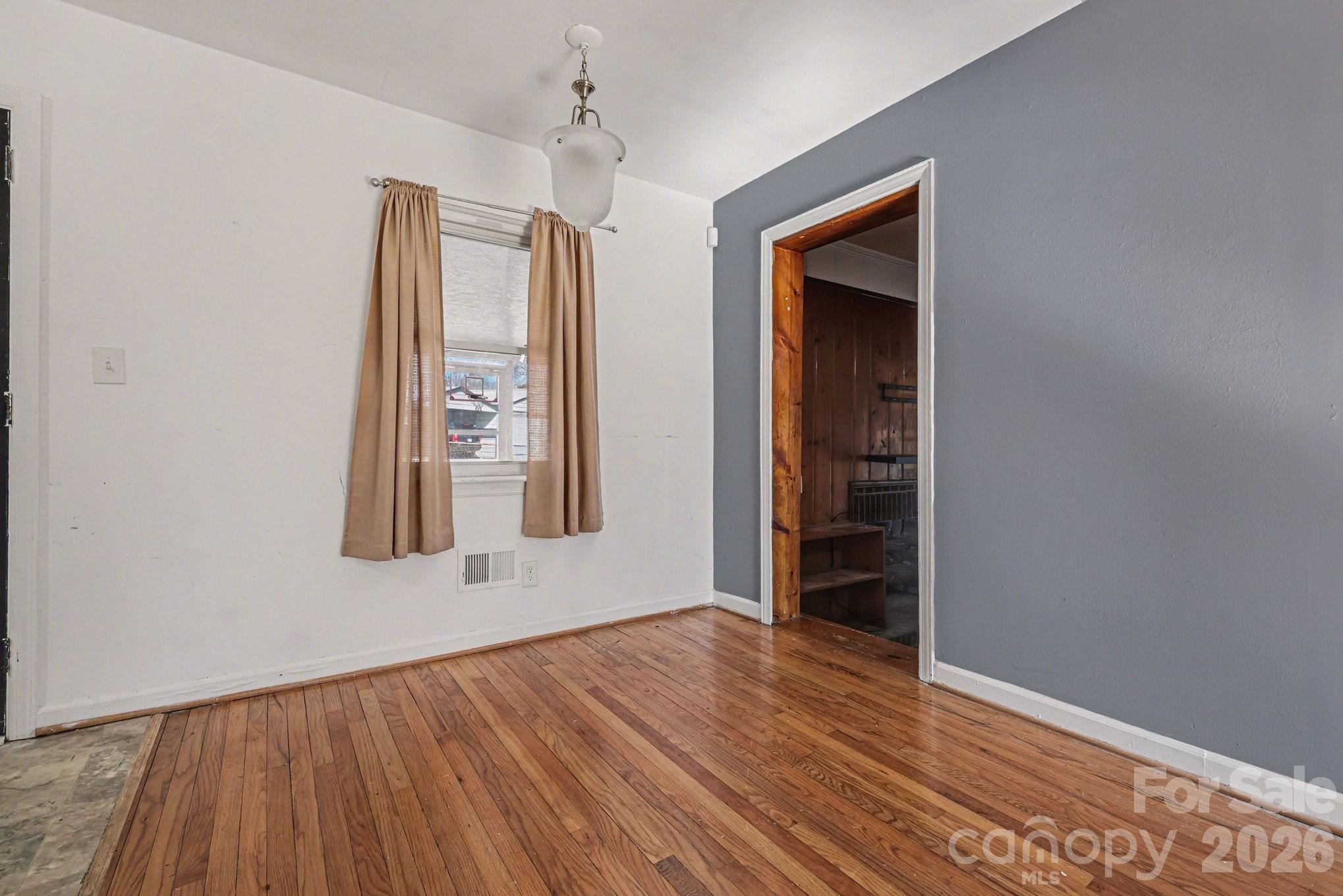 110 Abell Street Chester, SC 29706 - Photo 12 of 29 an empty room with wooden floor and windows