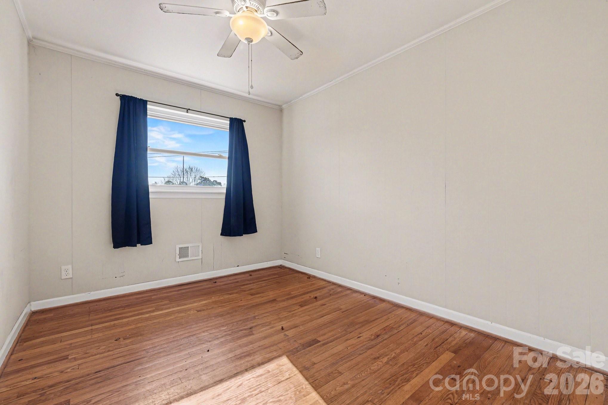 110 Abell Street Chester, SC 29706 - Photo 18 of 29 a view of an empty room with wooden floor and a window