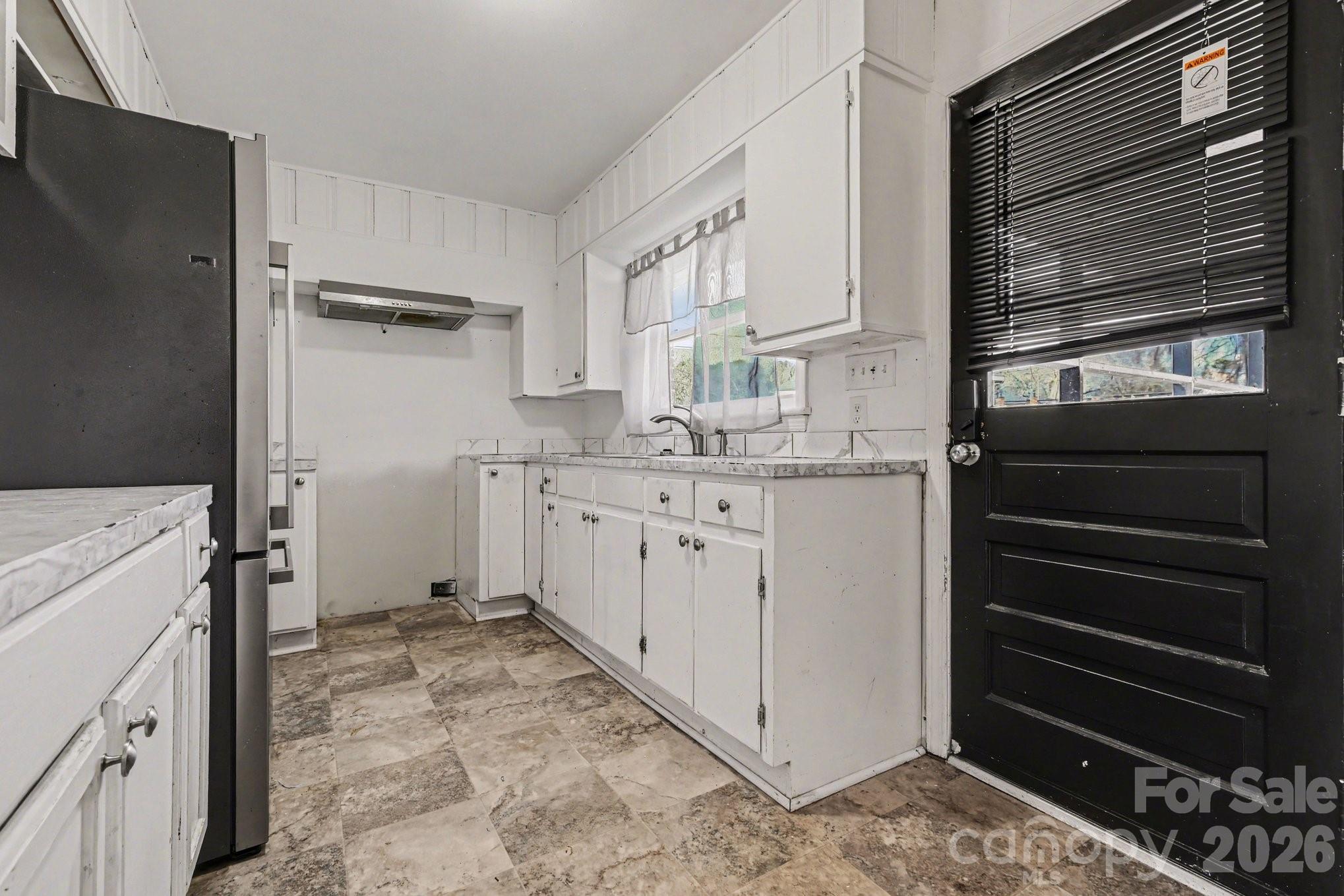 110 Abell Street Chester, SC 29706 - Photo 10 of 29 a kitchen with a refrigerator stove and white cabinets