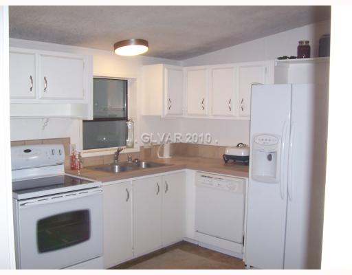 2891 Retread Road Pahrump, NV 89048 - Photo 3 of 17 Kitchen. KITCHEN RECENTLY RENOVATED, TILE COUNTERS, NEW APPLIANCES, SS SINK
