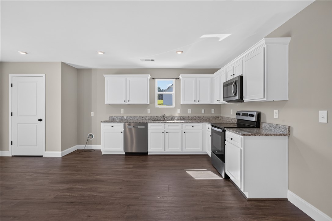 2007 Aberdeen Lane Walhalla, SC 29691 - Photo 5 of 41 Bright, modern kitchen with rich hardwood flooring and sleek stainless steel appliances.