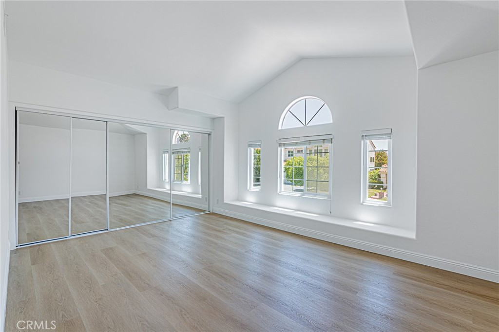 25533 Longfellow Place Stevenson Ranch, CA 91381 - Photo 19 of 47 an empty room with wooden floor and windows