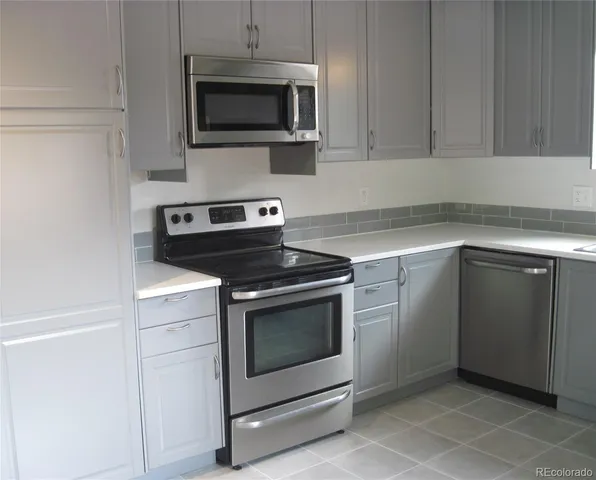 a kitchen with a stove and a microwave