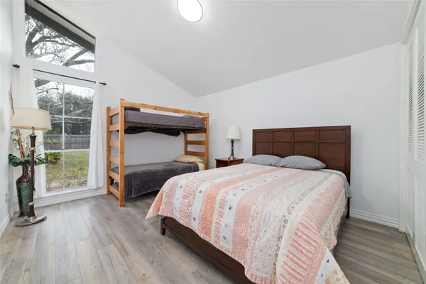 a bedroom with a bed and a mirror