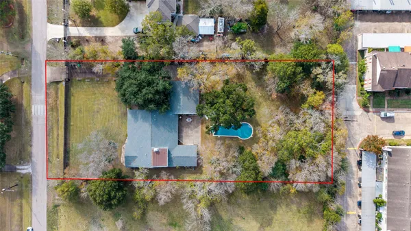 an aerial view of residential house with outdoor space and swimming pool