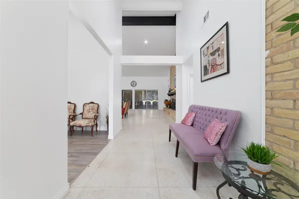 a living room with furniture and a potted plant