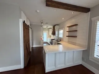 a bathroom with a sink a large mirror and a shower