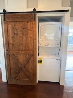 a view of a hallway with wooden floor and windows