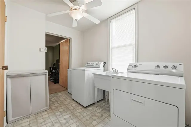 a utility room with cabinets washer and dryer