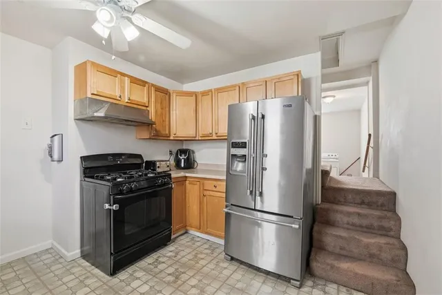 a kitchen with stainless steel appliances granite countertop a stove a refrigerator and a refrigerator
