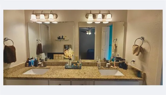 a bathroom with sink mirror and double