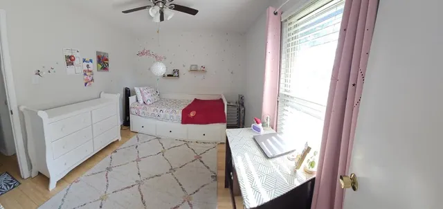 a bedroom with a bed and a dresser