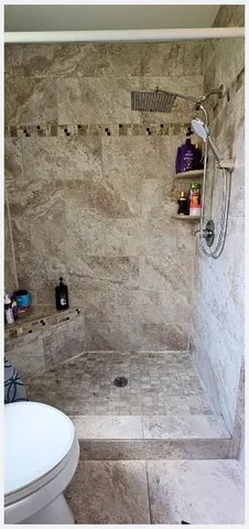 a bathroom with a toilet a sink and a mirror