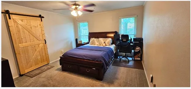 a living room with a bed furniture and a window