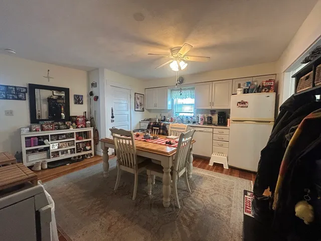 a view of a dining room with furniture and a window