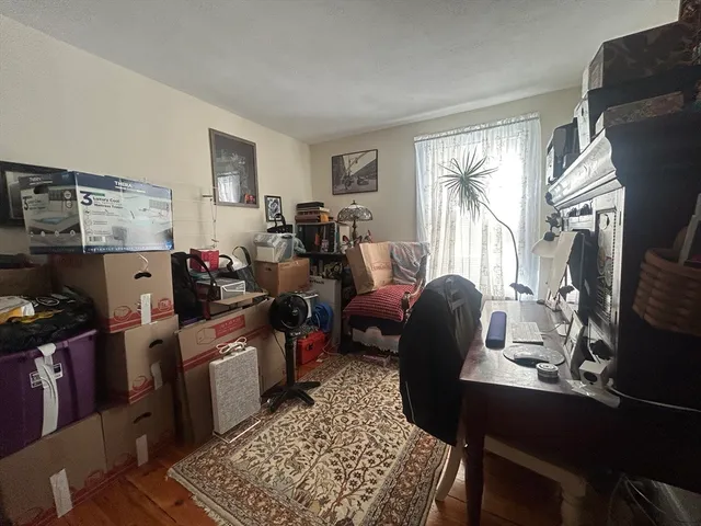 a room with furniture a rug a window and a window