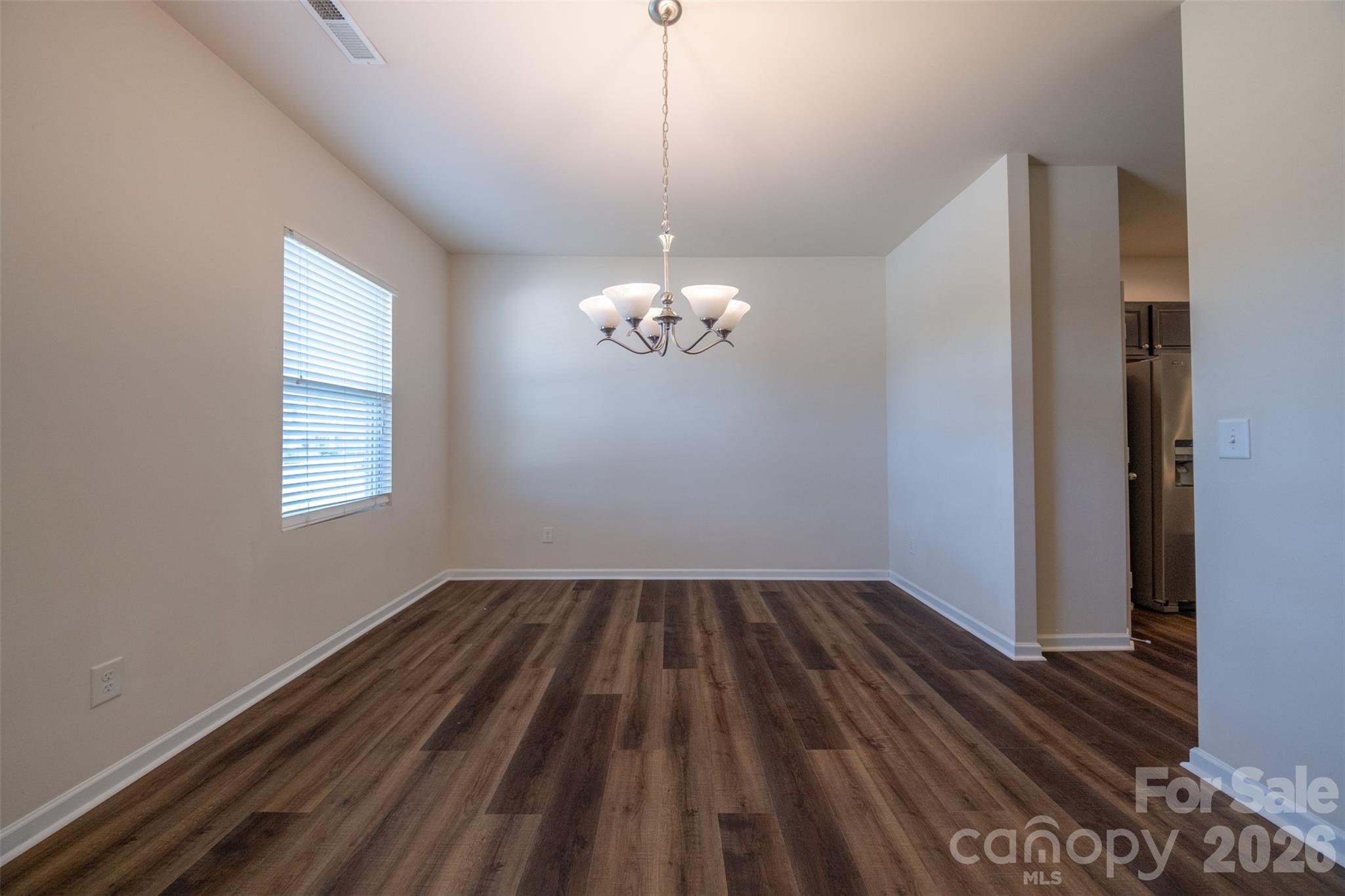 3006 Houndscroft Road Indian Trail, NC 28079 - Photo 6 of 39 a view of a room with wooden floor chandelier and window