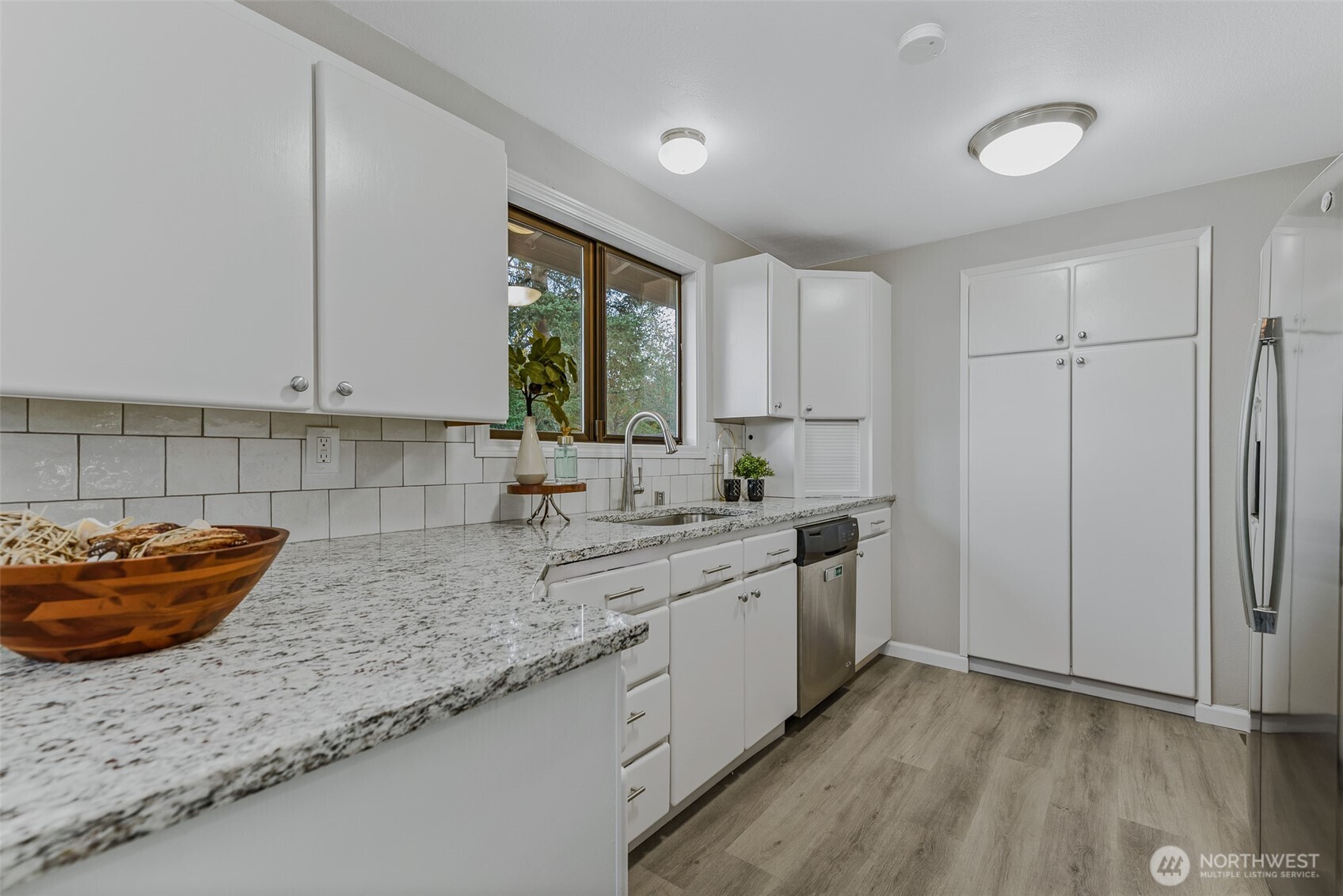 3162 Northwest Kent Street Camas, WA 98607 - Photo 17 of 40 a kitchen with stainless steel appliances granite countertop a sink stove and cabinets