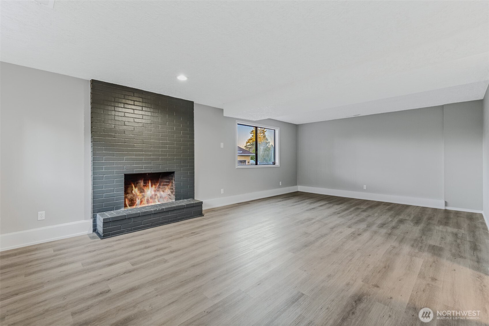 3162 Northwest Kent Street Camas, WA 98607 - Photo 29 of 40 a view of an empty room with wooden floor fireplace and a window