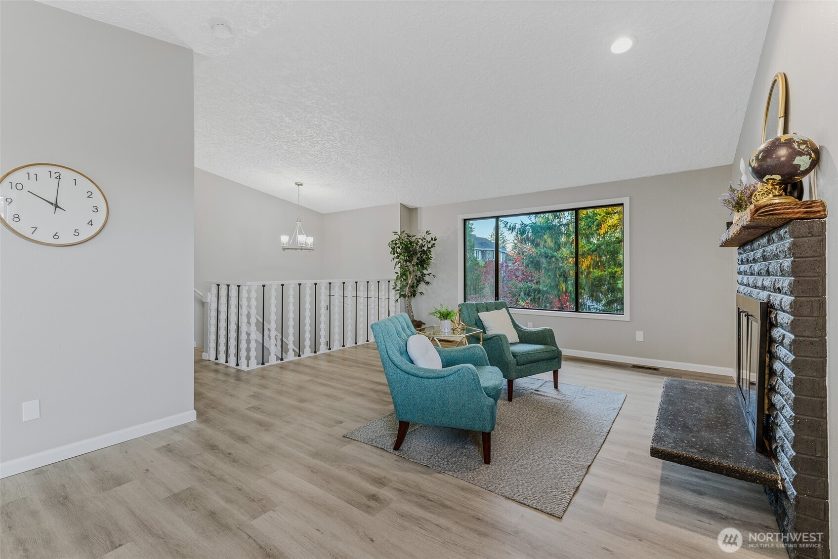 3162 Northwest Kent Street Camas, WA 98607 - Photo 8 of 40 a living room with furniture a fireplace and a large window
