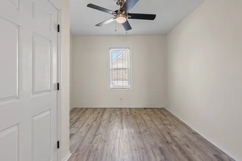 wooden floor in an empty room with a window