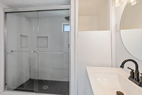 a bathroom with a sink and a shower