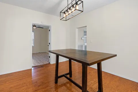 a view of a room with furniture and wooden floor