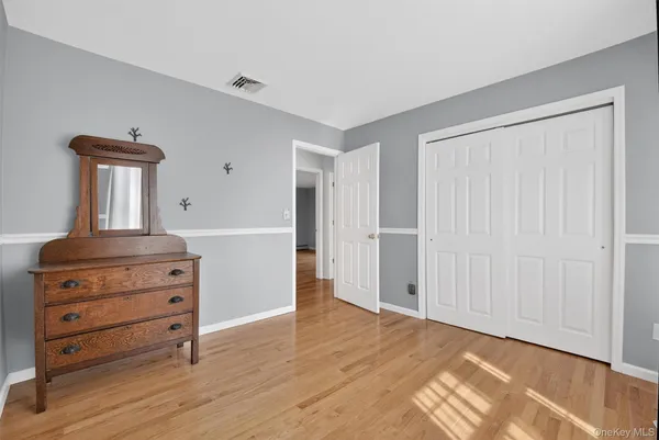a view of a dresser with wooden floor