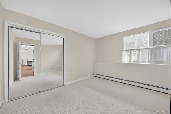 an empty room with windows and closet