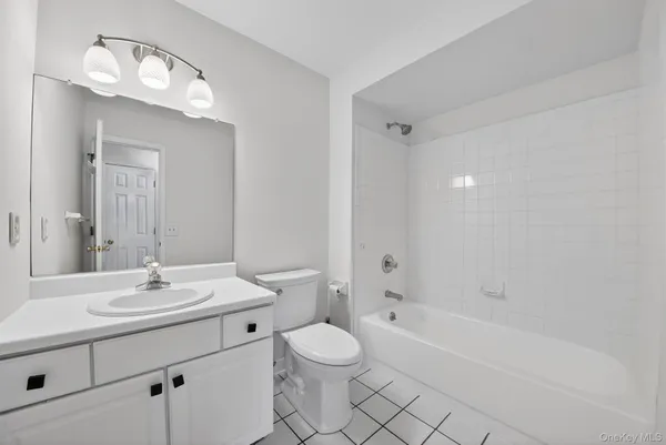 a bathroom with a sink toilet tub and shower