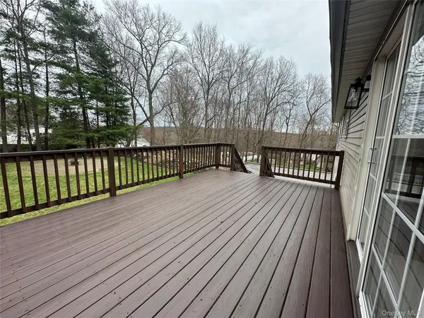 a view of a porch with a table and chairs