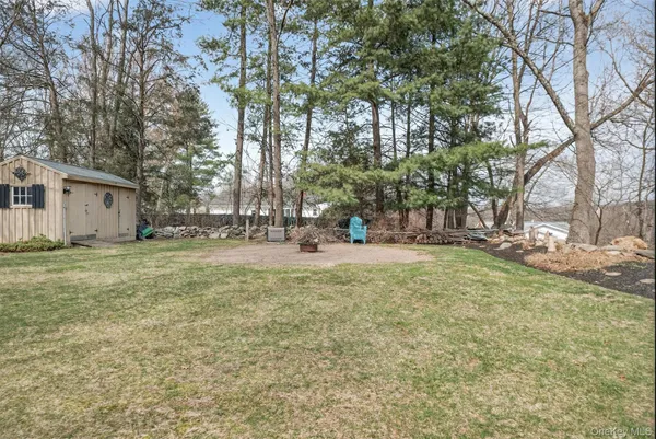 a view of a house with a yard and sitting area