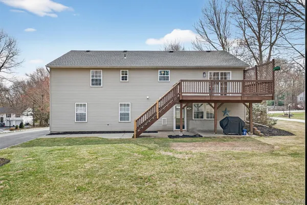 a view of a house with a yard and sitting area