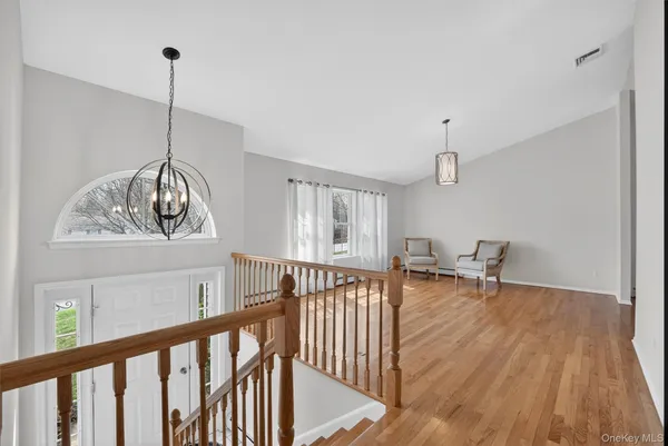 a view of a room with wooden floor and windows