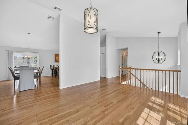 a view of a room with wooden floor and windows