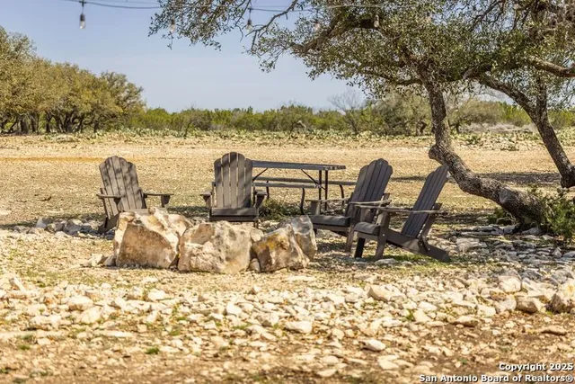 a view of a lake with table and chairs