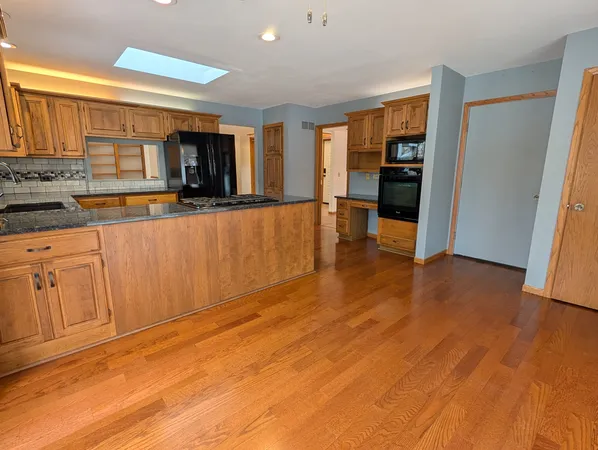 a view of a kitchen with a sink cabinet and a living room
