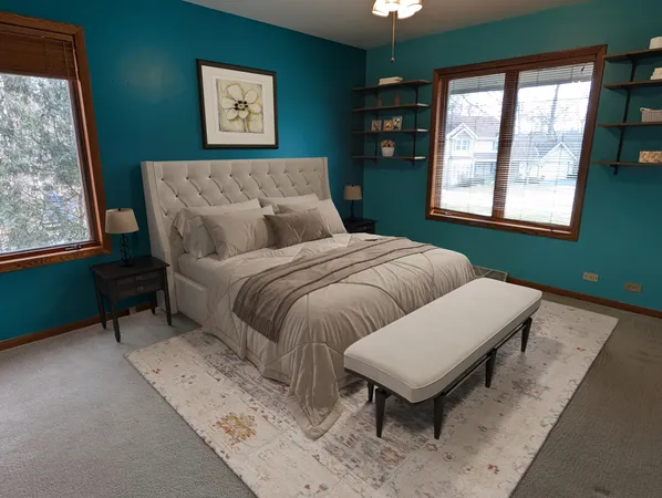 a bed sitting in a bedroom next to a window