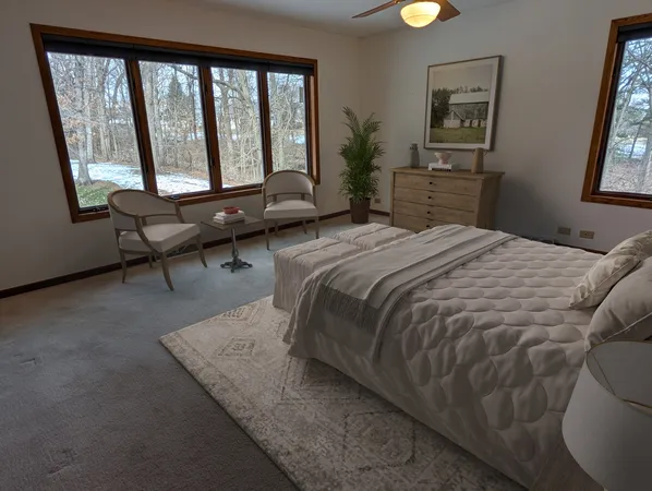 a bedroom with a bed couch and a window